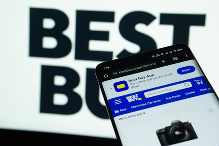 Dhaka, Bangladesh- 03 July 2025: Smartphone displaying Best Buy web interface against Best Buy logo background.のeditorial素材