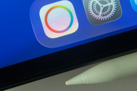 16 Nov 2025- Dhaka, Bangladesh: Payoneer and other app icons with a digital pen on a iPad screen.