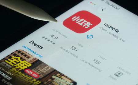 Dhaka, Bangladesh- 30 Oct 2025: rednote app on a iPad screen with a pen pointing at the install option.のeditorial素材