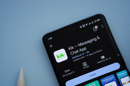Dhaka, Bangladesh- 29 May 2025: On a blue surface, a smartphone displays the Kik app within the...