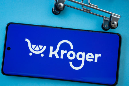 Dhaka, Bangladesh- 03 July 2025: Smartphone screen showing the Kroger logo with shopping cart wheels...