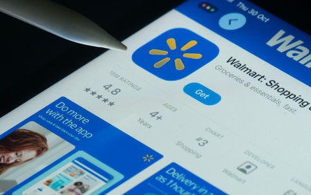 Dhaka, Bangladesh- 30 Oct 2025: Walmart app on a iPad screen with a pen pointing at the install...