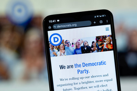 Dhaka, Bangladesh - 05 May 2026: Close-up of Democratic Party's homepage on a smartphone.