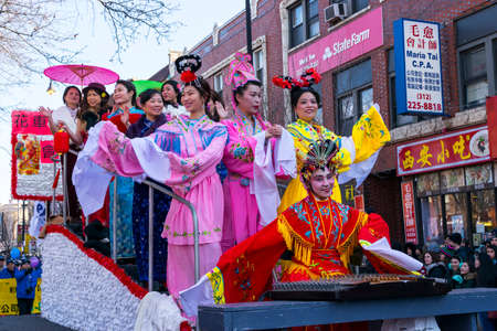 Chicago, IL, United States - February 5, 2017: Women dressed in trafitional Chinese outfits participate in Chinese New Year's Parade in Chinatown in Chicago, IL.のeditorial素材