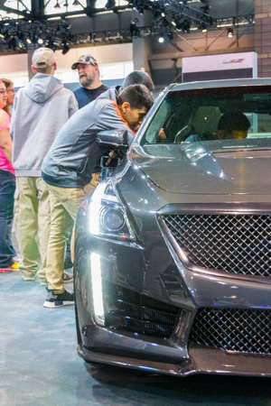 Chicago, IL, United States - February 18, 2017 - Chicago Auto Show: Young man is looking at Cadillac's interior at the 2017 Chicago Auto Show.のeditorial素材