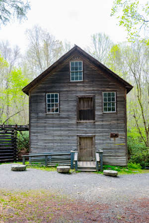 A shot of an abandoned water mill in a wooded area.の写真素材
