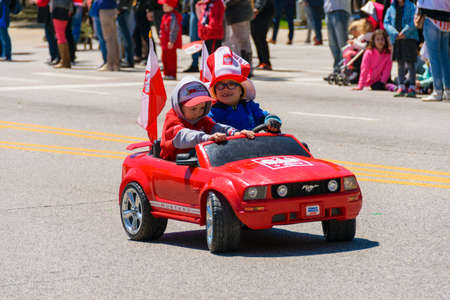 Chicago, IL, United States - May 06, 2017: Young children parading in a toy car during The Polish Consitution Day Parade in Chicago.のeditorial素材