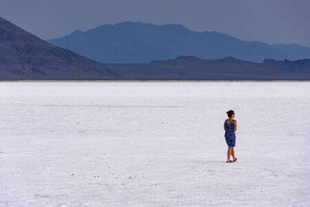 Bonneville Salt Flats, Utah, United States - August 15, 2018: Woman walking alone on the Bonneville Salt Flats in Utah.のeditorial素材