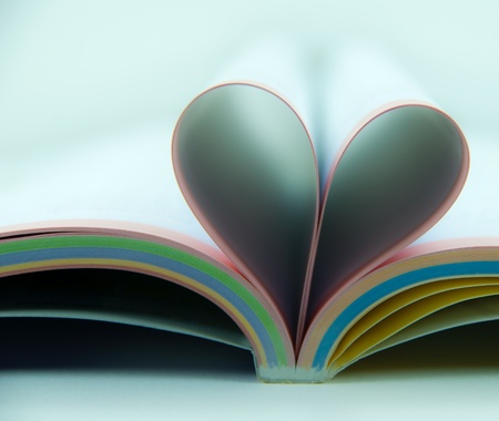 Pages of a book curved into a heartの写真素材
