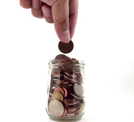 Hands generations putting coins in a glass jar, for saving concept.の写真素材