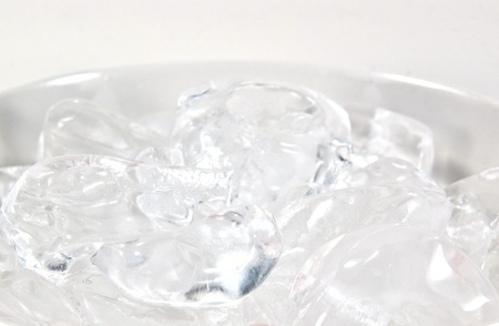 Close up of glistening ice in an ice bucket.の写真素材