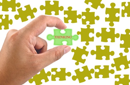 Hand hold the Thinking word on jigsaw puzzle pieceの写真素材