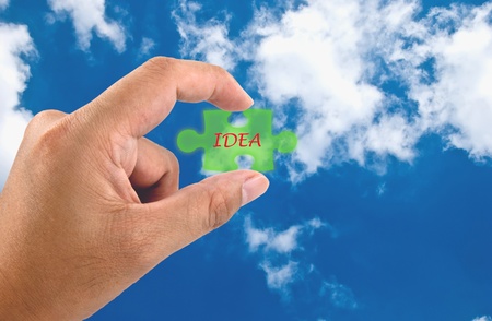 Hand hold the IDEA word on jigsaw puzzle pieceの写真素材