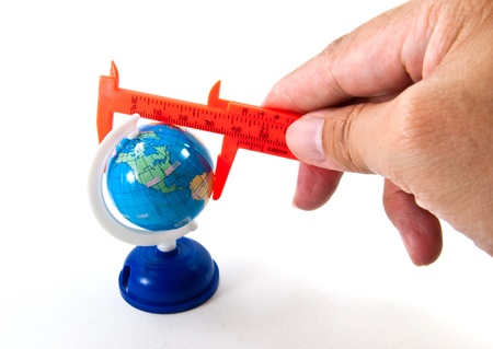 Globe with caliper on handの写真素材