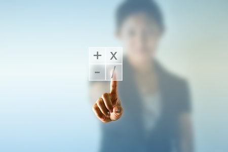 Business woman pressing virtual math symbol 