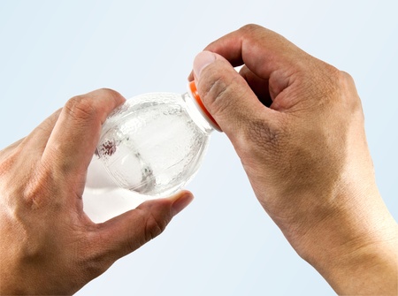 Hand opening a bottle of water 