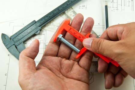 Technical drawing and tools in hand の写真素材