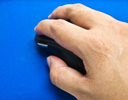 Wireless optical mouse in hand の写真素材