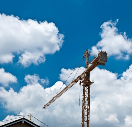 Construction crane with blue skyの写真素材