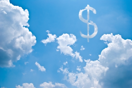 A dollar sign cloud in a blue skyの写真素材