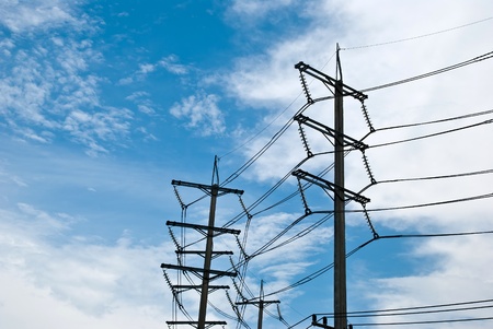 Power transmission tower against the blue sky background 
