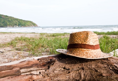 Straw hat over the timber on the beach.の写真素材