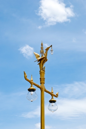 Golden swan, Thai style light pillar lantern with blue skyの写真素材