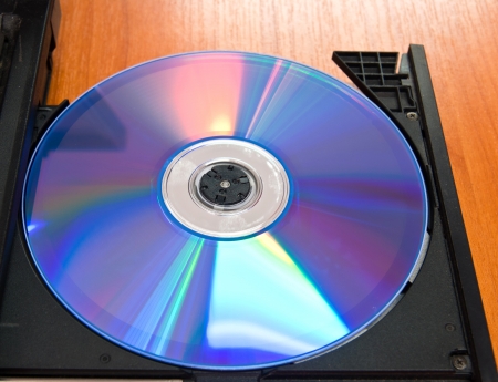 Laptop with dvd disk in slot-loading driveの写真素材