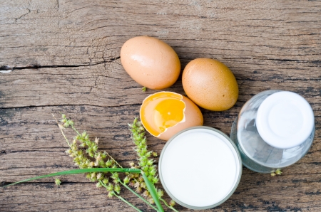 Eggs and milk on wooden background の写真素材