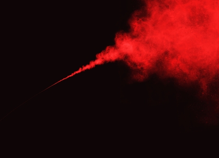 Elegant Freeze motion of Abstract Red Smoke or Powder Exploding on Black Background with Copy Space for Text Decorated の写真素材
