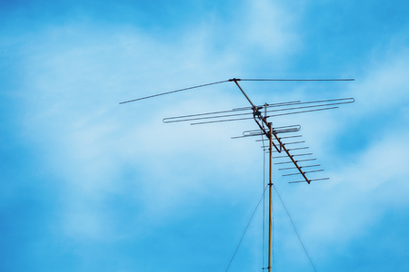 Television antenna on cloudy blue skyの写真素材
