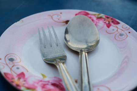 Spoon and fork on plateの写真素材