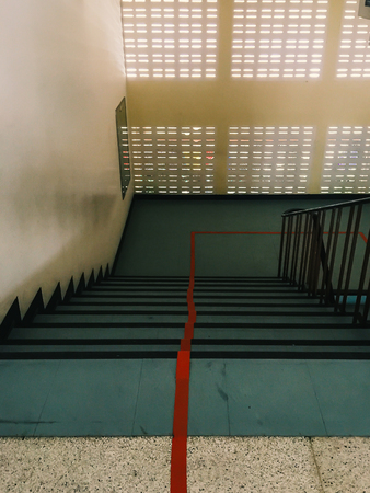 Staircase which the red line to divide into two lanes : up and down (mobile photography)の写真素材
