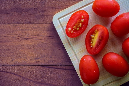 Fresh red cherry tomato on wooden tableの写真素材