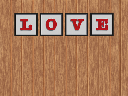 Word "LOVE" in black frame on the wood backgroundの写真素材