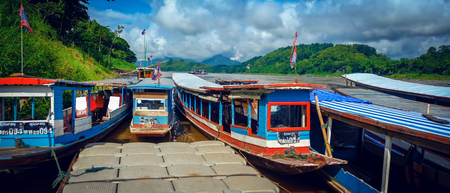 LUANG PRABANG, LAOS, JUNE 25, 2016 : Tour boats at the shore of the Mekong River to bring tourists to cruise in Luang Prabang, Laosのeditorial素材