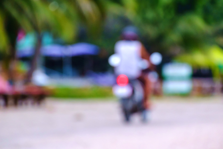 Blur image of man riding motorcycle on the sand beachの写真素材
