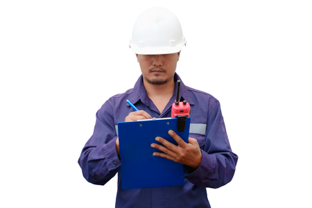 Asian engineer in safety uniform and white helmet taking note on clipboard isolated on white background, industrial conceptの写真素材
