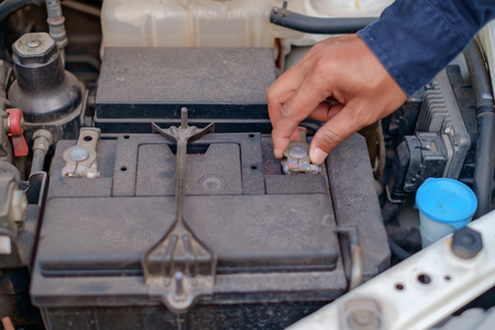 Hand checking and repairing car battery for travel safety conceptの写真素材