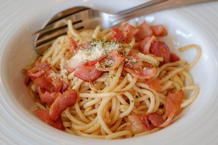 Spaghetti with bacon in white plate for eating concept, selective and soft focus imageの写真素材