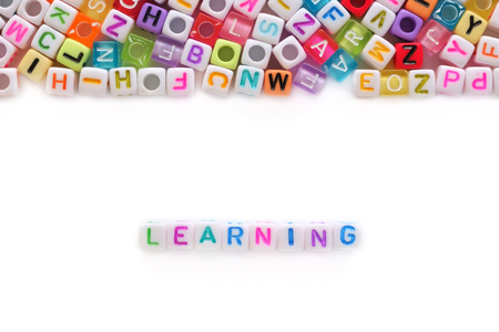 LEARNING word and alphabet letter beads on white background for education concept