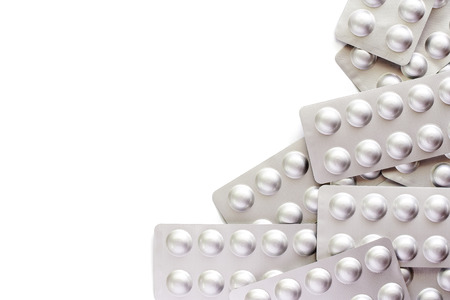 Medicine, pills, drug or tablets in a blister pack on white background for healthcare and medical...