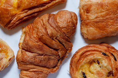 Top view of delicious bread on white marble background for food, bakery and eating conceptの写真素材