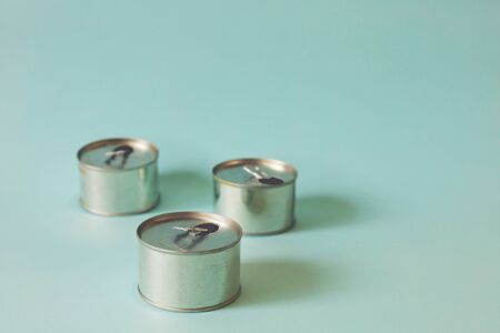 Tin can against light blue background for waste recycling conceptの写真素材