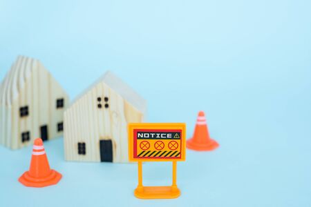 Prohibition sign with blurred wooden house model on blue background for self-quarantine and staying home in coronavirus or Covid-2019 situation conceptの写真素材