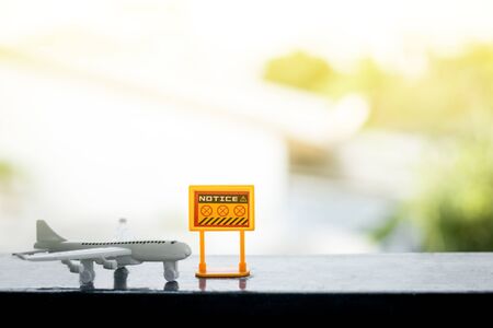 White airplane model with prohibition sign on blurred outdoor background for vehicle and transportation in coronavirus or Covid-2019 situation conceptの写真素材