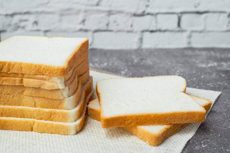 Sliced bread on dark grunge background for bakery, food and eating concept