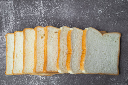 Sliced bread on dark grunge background for bakery, food and eating concept