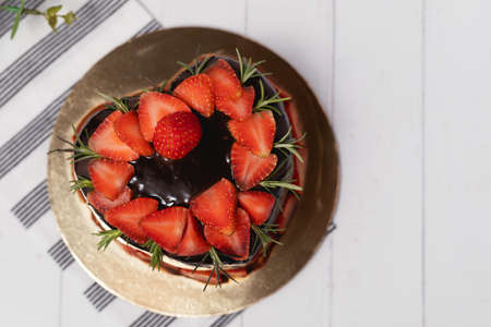 Heart shaped of delicious chocolate cake with strawberries on white background for food and bakery conceptの写真素材