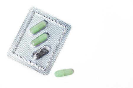 Green chiretta herbal capsule on white background with copy space for healthcare and medical concept